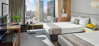 A living room filled with furniture and a large window Description generated with very high confidence